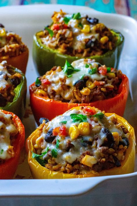 Mexican Stuffed Peppers are made by stuffing colorful bell peppers with ground beef, rice, cheese and all of your favorite Mexican-inspired flavors. The perfect easy weeknight meal, these Mexican Stuffed Peppers are healthy, delicious and a new twist on classic stuffed peppers. | A Wicked Whisk #stuffedpeppers #stuffedpeppersbeefandrice #mexicanstuffedpeppers #mexicanstuffedbellpeppers #mexicanstuffedpeppersbeef #mexicanstuffedpepperseasy #southweststuffedpeppers Stuffed Bell Peppers Ground Beef, Healthy Stuffed Bell Peppers, Southwest Stuffed Peppers, Classic Stuffed Peppers, Vegan Stuffed Bell Peppers, Stuffed Bell Peppers Chicken, Stuffed Peppers Beef, Mexican Stuffed Peppers, Taco Stuffed Peppers