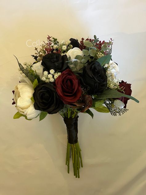 ,CcfloralsWedding bouquet,Burgundy black white flowers Fall bridal bouquet  green Bridesmaid bouquet Halloween wedding bouquet, Boho bouquet  bride bouquet measures 12-14" in width and height  bridesmaids bouquet measures 8-10" in width and height  featured colors are : black, burgundy white  mix of high quality artificial flowers, roses and eucalyptus  *custom orders are always welcomed send us a message  Capture the essence of fall with our Autumn  Artificial Wedding Flowers. Featuring a stunning blend of vibrant autumn hues, these meticulously crafted flowers bring the warmth and beauty of the season to your special day. Perfect for bouquets, centerpieces, and decor, they offer timeless elegance without the worry of wilting. Make your wedding unforgettable with the vibrant colors and ev Black Rose Wedding Bouquet, Red Black Gold Bouquet, Halloween Wedding Bouquet Ideas, Black And Red Flower Bouquets, Red White And Black Wedding Theme, Flower Bouquet Aesthetic Dark, Black And Burgundy Wedding Decorations, Gothic Wedding Flowers, Gothic Wedding Bouquet