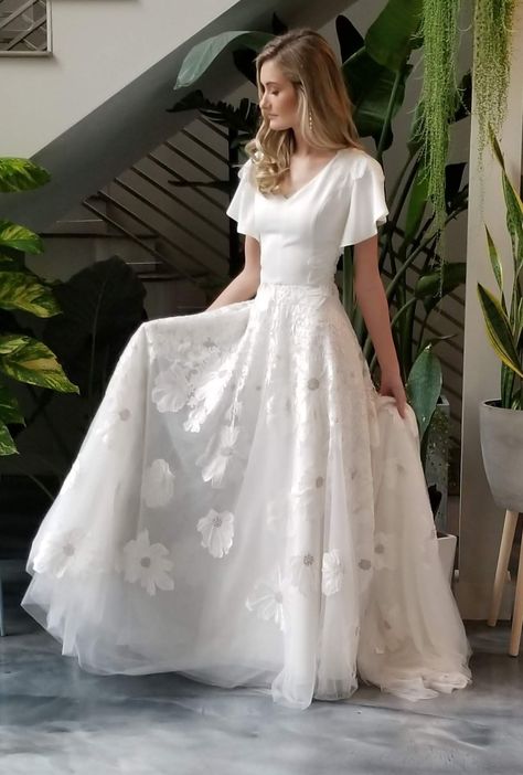 modest wedding dress || wedding dress with flutter sleeves || lace bridal gown ||lds wedding || lds bride || crepe wedding dress || bridal designer || alta moda modest dress || eridani bridal   #mdoestweddingdress #weddingdress ##bridalgown Wedding Dress With Flutter Sleeves, Bohemian Style Gown, Wedding Dresses Lds, Lds Bride, Dress With Flutter Sleeves, Traditional Gowns, Modest Wedding Gowns, Modest Wedding Dress, Crepe Wedding Dress