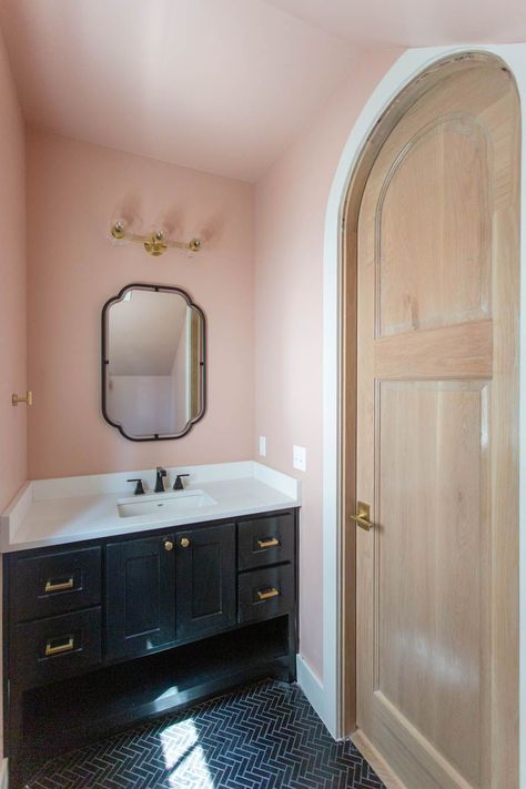 Blush pink powder bathroom with black vanity detail; herringbone black tile floors Black Floor Pink Walls, Blush Pink And Black Bathroom, Blush And Navy Bathroom Ideas, Pink Black And Gold Bathroom, Old Pink Bathroom, Black White And Pink Bathroom, Pink And Navy Bathroom, Bathroom With Black Vanity, Black And Pink Bathroom