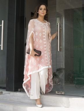 This summer season try the trendy Cape Kurtis. Know the various Cape Style Kurti Designs and patterns that are perfect for any casual occasion. White Pants, A Woman, Cape, Glass, Pants, Pink, White, Trousers