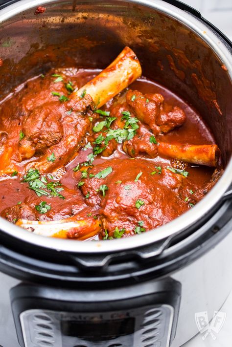 Beautifully tender, fall-off-the-bone lamb shanks are possible in a fraction of the time thanks to an electric pressure cooker! This Instant Pot Braised Lamb Shanks with Tomato recipe takes just a few ingredients and minimal effort. Serve it over mashed potatoes or polenta for a perfect comfort food dinner. #lamb #comfortfood #InstantPotRecipes #easyrecipes #lambrecipes #weeknightdinner #SundaySupper #familymeal Lamb Shanks Pressure Cooker, Pressure Cooker Lamb, Lamb Shanks Slow Cooker, Lamb Shank Recipe, Roast Chicken Dinner, Braised Lamb Shanks, Over Mashed Potatoes, African Dishes, Tomato Recipe