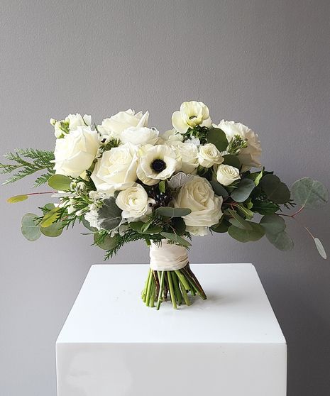 WCBQTMD17,WCBQTSM17,WCBQTLG17 A gorgeous classically styled bouquet featuring a blend of white roses, white spray roses, white stock, ranunculus, and anemone, soft dusty miller, flat cedar, and other textures, hand-tied with a ribbon wrapped stem. Perfect for holiday destination weddings, courthouse surprises, and romantic elopements.(No Vase Included) White Rose And Anemone Bouquet, All White Bouquet Wedding, Anemone Flower Bouquet, Wedding Anemone, Winter Wedding Flowers Bouquets, Anemone Bridal Bouquet, Benedict Casserole, Ranunculus Wedding Bouquet, Ranunculus Wedding