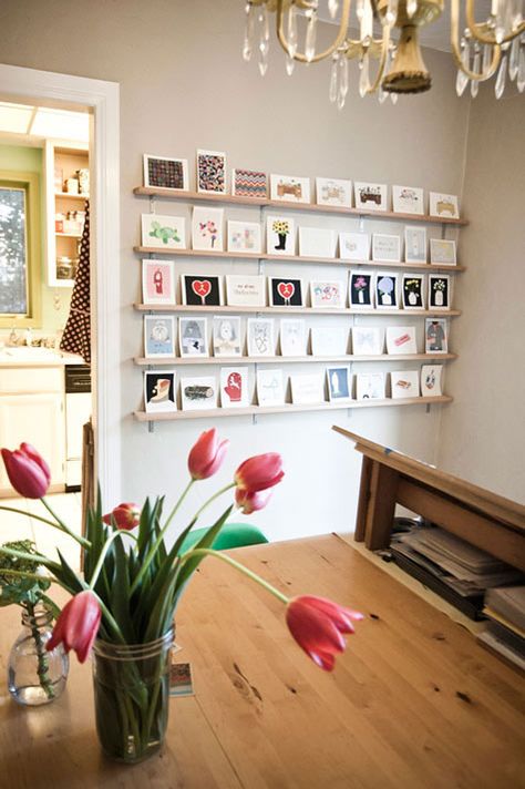 Maybe we can get some ledge shelves (in white?) and put them on the wedding wall to showcase the wedding cards we've gotten. Postcard Display, Photowall Ideas, Photo Ledge, Postcard Wall, Display Family Photos, Photo Mural, Wedding Wall, Decoration Originale, Design Sponge