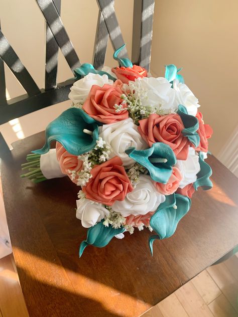 "Check out our current coupons here: https://www.touchofamorfloral.com/general-5 11\"-12\" Bridal Bouquet 8\"-9\" Bridesmaid Bouquet 6\"-7\" Jr. Bridesmaid Bouquet/Toss Boutonniere - Calla Lily and Miniature Coral Rose Bouquets are handmade for your special occasion. High-quality silk teal roses with a choice of white or ivory soft-touch foam roses and realistic faux greenery are used to give your bouquet a vivid, natural look that will never wilt! For special requests or color/size variations, please message me, and I would love to work with you to make your dream bouquet for your special event or home decor. Custom orders and bouquet re-creation orders are also available upon request. If you would like an artificial flower replica of a special bouquet from your past or please message me Teal And Coral Flower Arrangements, Coral Teal Wedding, Aqua And Coral Wedding, Coral And Turquoise Wedding Colors, Teal And Peach Wedding, Beach Wedding Bouquet Ideas, Turquoise And Coral Wedding, Coral And Teal Wedding, Beach Bridal Bouquet