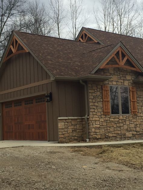 Brown Metal House Exterior, Brown Siding And Stone Exterior, Dark Brown Farmhouse Exterior, Rock And Wood Exterior Homes, Brown Rock House Exterior, Cedar Shake Siding Accent With Brick, Brown Cedar House Exterior, Dark Brown Siding House Color Schemes, Chocolate Brown Exterior House Colors