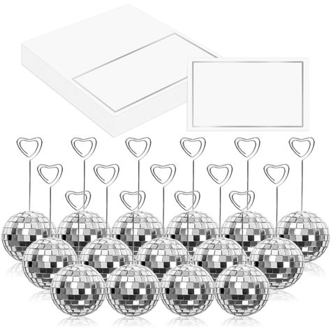 PRICES MAY VARY. Package Includes - You will receive 20pcs of disco ball card holders, 20pcs of heart swirl wires and 20pcs of tented cards, complete and value set to meet your various needs. Dazzling Silver Look - Bling silver disco ball bases with heart swirl wire, and place cards with silver foil frame, our place cards and holders set are delicate and glamourous, which can light your guests eyes up and leave them deep impressions. Good Quality - The disco ball stands that made of foam and dec Disco Ball Table, Disco Ball Wedding Decor, Disco Birthday Party, Couples Bridal Shower, Table Number Holders, Disco Theme, Wedding Display, Wedding Party Table, Paper Place