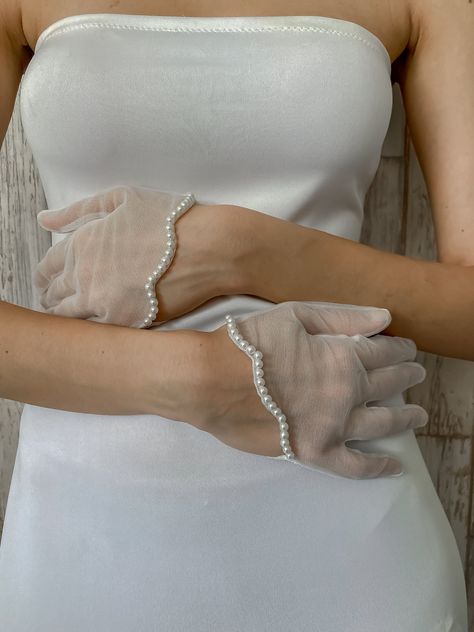 Kerry Parker Store's Epiphany Pearl Scalloped Tulle Gloves @KerryParkerOfficial The elegance of pretty pearls combined with the ever so classic tulle, in a diamond white shade. With asymmetric scallops across the hem. Available in 2 Lengths - Short (Wrist length) & Long (Elbow length) Made To order Limited edition Material - Silk Tulle, Tulle Gloves With Pearls, Pearl Gloves, Tulle Gloves, Wedding Tulle, Formal Gloves, Princess Diaries, Mia 3, Evening Formal, Epiphany