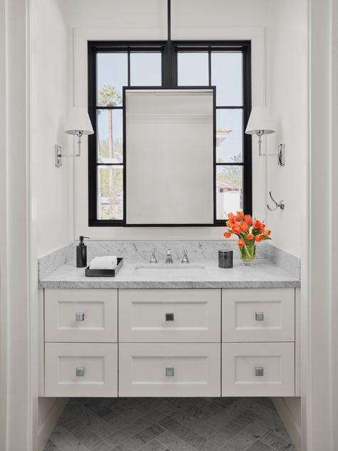 Custom steel mirror hanging in front of window in luxurious guest bathroom powder room #marble #hangingmirror #floatingvanity #luxuryhome #luxurybathroom @_integrateddesign_ @lissaleehickman 📸 @roehnerryan