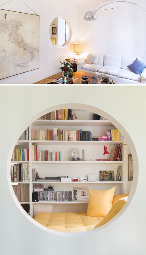 This modern home features an elevated reading nook that sits next to a window and a floor-to-ceiling bookshelf, and that has an opening that looks into the living room. #ReadingNook #InteriorDesign #CozyNook #Nook Wall Cutout Ideas Living Room, Circular Bookshelf, Ceiling Bookshelf, Wall Cutout, Wall Cut Out, Home Bar Cabinet, Bedroom Nook, Side Extension, Kids Room Murals