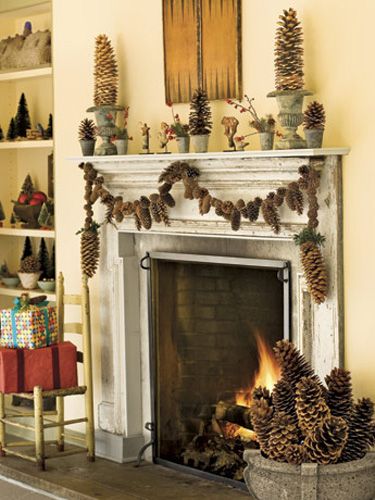 Brawny sugar pinecone swags anchor a mixed-cone garland above the fireplace. Make it yourself with a variable-speed drill and braided picture-hanger wire. Place inverted cones in urns to create quick-and-easy pinecone topiaries. Christmas Fireplace Mantels, Pinecone Garland, The Mantle, Fireplace Mantel Decor, Christmas Fireplace Decor, Rustic Fireplaces, Christmas Tablescape, Pine Cone Decorations, Holiday Garlands