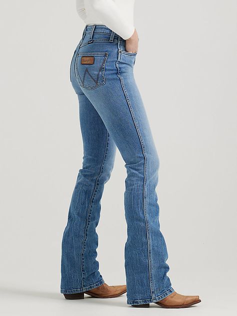 EVERY COWGIRL’S GO-TOTrends may come and go, but the bootcut is forever. Our Women’s Wrangler Retro® Bailey High Rise Bootcut Jean sets the bar high with a waist-nipping silhouette, a close fit through the thigh, and a slightly flared 17” leg opening that goes perfectly over boots. It’s crafted from cotton with just a subtle amount of stretch for comfort. Plus, the signature five-pocket styling, “W” stitching, and rope logo patch deliver the Western authenticity you want. Women’s Cowgirl Outfit Ideas, Womens Wrangler Outfits, Bootcut Jeans Outfit Country, Wrangler Jeans Women's Outfit, Formal Western Wear Woman, Boot Cut Jeans Outfit, Cowboy Clothes, Wrangler Jeans Women's, Bootcut Jeans Outfit