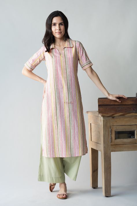 Tailored out of 100% premium cotton, Sabrang is a graceful play of colors to brighten your everyday outfit. The vertical lines of color are sure to add a few inches to your height visually. The collared neckline and elbow sleeves add to the chic beauty of Sabrang. Balance out the colorful playfulness with our neutral pistachio green palazzo. Straight Kurti Designs Cotton, Collar Kurta Designs Women, Kurta Designs Women Casual, Stitch Dress, Fashionable Saree, Kurta Women, A Line Kurti, Stylish Kurtis Design, Tie Dye Tops