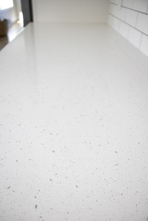 The most timeless quartz options are simple and neutral like in this picture! Terrazzo Look Countertops, Quartz Countertops Speckled, White Speckled Quartz Countertop, Frost White Quartz Countertop, Terrazo Countertops Kitchen, Simple Granite Countertops, White Speckled Countertops, Speckled Quartz Countertops, Composite Kitchen Countertops