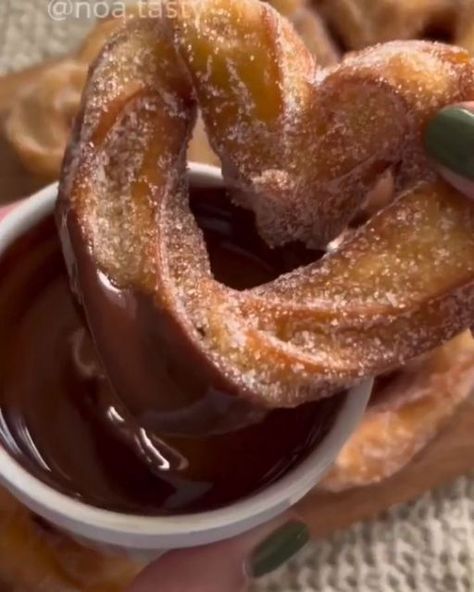 Sweettheavens on Instagram: "Heart-shaped churros 🎥 Credits @noa.tasty Follow @sweettheavens for more 🧁 Ingredients for 10 heart-shaped churros: 50g of butter Half a cup of lukewarm water (120ml) Half a teaspoon of vanilla extract 1 tablespoon of sugar A pinch of salt Half a cup of flour (70g) 2 eggs Sugar mixture: a quarter cup of sugar + a quarter teaspoon of cinnamon Chocolate sauce: 50g of dark chocolate + a quarter cup of heavy cream Instructions: 1. Prepare the Dough In a saucepan, combine the butter, lukewarm water, vanilla extract, sugar, and a pinch of salt. Bring the mixture to a boil over high heat, stirring continuously. After about a minute and a half, the mixture should start to bubble. At this point, reduce the heat to low and add the flour. Stir the mixt Easy Baked Sweets, Sweet Dishes Recipes, Tasty Recipes Videos, Quick Recipes Snacks, Tasty Baking, Bread Recipes Sweet, Healthy Sweets Recipes, Delicious Snacks Recipes, Fair Food Recipes