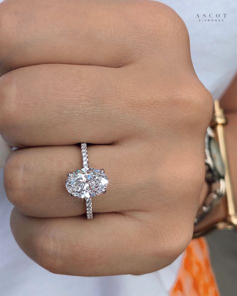 A resplendent, 2.13ct oval-cut lab grown solitaire diamond gracefully adorns the center of this breathtaking womens engagement ring. The shank features 26 beautifully brilliant round diamonds for extra shine. A stunning design by Ascot Diamonds #custom #diamonds #diamondring #engagementring #ovalcutdiamond #engaged Oval Engagement Ring 2 Ct, Engagement Rings Round And Oval, Paved Oval Engagement Ring, Diamonds Direct Engagement Rings, Single Oval Engagement Ring, Wedding Ring For Small Hands, Oval Brilliant Engagement Ring, Oval Engagement Ring Lab Grown, Oval Shaped Rings Engagement