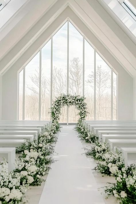 Bright and elegant wedding aisle with floral arrangements. Get enchanted by wedding decor ideas that remain elegant across the ages while impressing even the pickiest Aunt Mildred. White Rose Wedding Aisle Decor, White Wedding Aisle Runner, Outside Wedding Aisle Runner, Isle Rugs Wedding, Wedding Floral Aisle Arrangements, Minimal Wedding Aisle Decor, Wedding Aisle Decorations Indoor Church, Wedding Outdoor Aisle, Alter Flower Arrangement