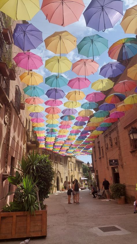 Rainbow Umbrellas at Poble Espanyol in Barcelona, Spain Vision Board Pictures Travel Spain, Barcelona Spain Travel Aesthetic, Poble Espanyol Barcelona, Summer In Barcelona Aesthetic, Barcelona Spain Beach, Spain Barcelona Aesthetic, Barcelona Beaches, Barcelona Spain Aesthetic, Poble Espanyol