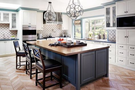 Gorgeous kitchen boasts two glass and iron faceted pendants illuminating a blue kitchen island topped with butcher block fitted with a small prep sink and hook and spout faucet lined with wood x back counter stools with navy leather nailhead seat cushions atop a brick herringbone floor. Kitchen Island Stools With Backs, Wood Island Countertop, Elegant Kitchen Island, Blue Kitchen Island, Kitchen Island Tops, Wood Countertops Kitchen, Butcher Block Island Kitchen, Kitchen Island With Sink, Butcher Block Top