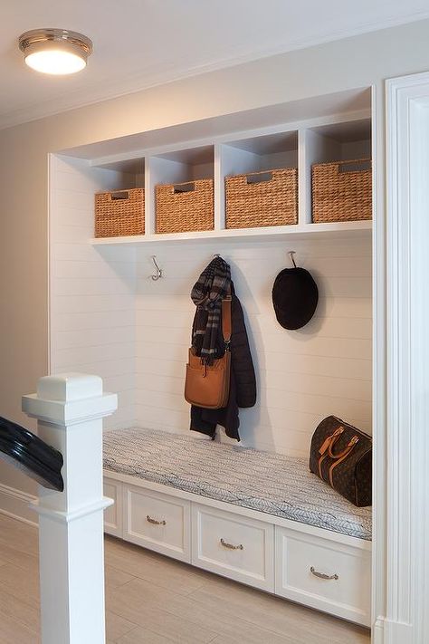 A recessed mudroom alcove is filled with a built-in bench fitted with four with drawers tucked four coat hooks lining a shiplap wall accented with overhead shelves filled with woven bins. Overhead Shelves, Alcove Storage, Foyer Bench, Kitchen Storage Bench, Mudroom Cubbies, Wall Shelf With Hooks, Recessed Shelves, Shelf With Hooks, Log Home Interiors