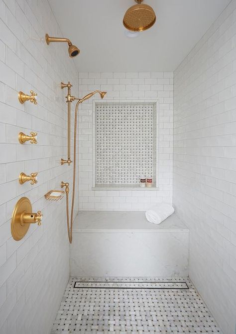 Fresh shower design fitted with white glazed tiles accented with marble basketweave floors and a matching niche. Basketweave Tile Bathroom, Basketweave Tile Floor, Bathroom Shower Remodel, Fresh Bathroom, Amazing Showers, Gold Fixtures, Master Bath Remodel, Shower Niche, Bathroom Remodel Shower