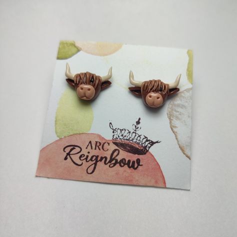 Brown polymer clay highland cow earrings with long hair covering one eye. Has tan horns Clay Earrings Animals, Cow Earrings Clay, Highland Cow Polymer Clay Earrings, Highland Cow Earrings, Highland Cow Clay Earrings, Polymer Clay Horse Earrings, Polymer Clay Western Earrings, Polymer Clay Highland Cow, Clay Cow Earrings