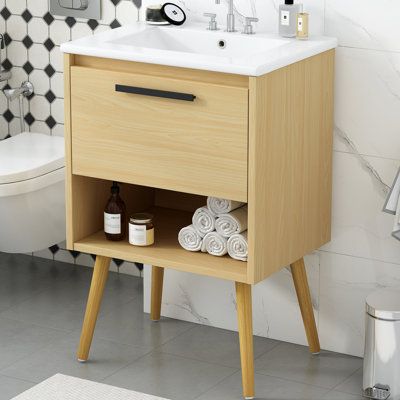 This freestanding single vanity brings a mid-century modern look to your bathroom or powder room. Featuring quality solid wood and MDF combines the natural warmth of wood with sleek finishes like composite stone and metal hardware. Its white, integrated sink boasts a rectangular shape that matches the rest of the clean-lined piece. A minimalist design and splayed legs give this vanity its modern edge. This durable and stylish piece is functional as well, with a generously sized drawer that neatl Bathroom Cabinet With Drawers, Bathroom Vanity With Sink, Vanity With Sink, Basin Sink Bathroom, Mdf Frame, Bathroom Vanity Cabinets, Bathroom Storage Cabinet, Basin Sink, Bathroom Sink Vanity