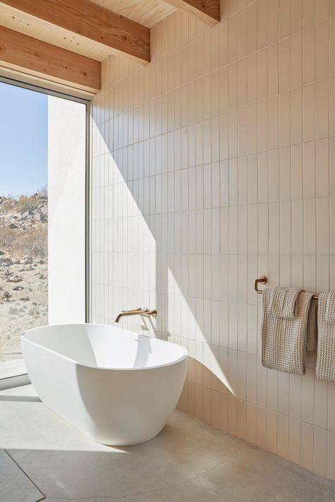 From soft, neutral tile to a sunlit soaking tub to the simplicity of the Odin® Bath Collection, every element of artist Heather Day’s home celebrates the stark beauty of the desert.

Photography: Joe Fletcher

Luxury Bathroom; Minimalist Bathroom; Desert Oasis; Floor to Ceiling Bathroom Windows; Interior Design; Exposed Wood Beams Ivory Bathroom, Handmade Tile Backsplash, Beams Ceiling, Desert Modernism, Heather Day, Exposed Beams Ceiling, Ceiling Bathroom, Tile Accent Wall, Tile Backsplash Bathroom