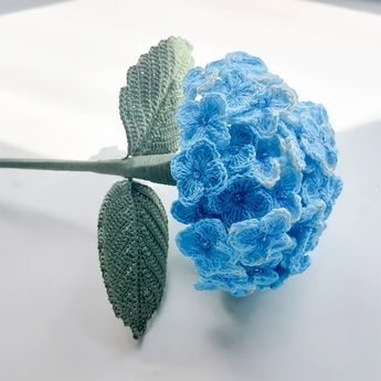 The hydrangea represents gratitude, grace, and beauty. Learn how to make some gorgeous hydrangeas with this tutorial. They look so realistic, and they'll never wilt on you! Crocheted Hydrangea Flowers, Crochet Flowers Hydrangea, Crochet Flowers Realistic, Beautiful Crochet Ideas, Crochet Blue Flowers Free Pattern, Hydrangea Crochet Pattern, Crochet Hydrangea Pattern Free, Microcrochet Flower, Free Flower Crochet Patterns