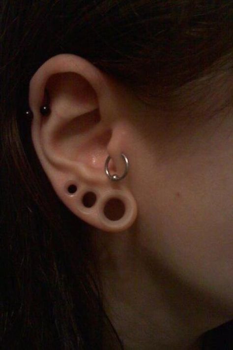 stretched ears. I love the look of this especially when the tunnels are black. Overcrowded Facial Piercings, Stretched Ear, Piercing Inspo, Emo Stuff, Face Piercings, Cool Piercings, Marshall Lee, Cute Piercings, 1 Tattoo