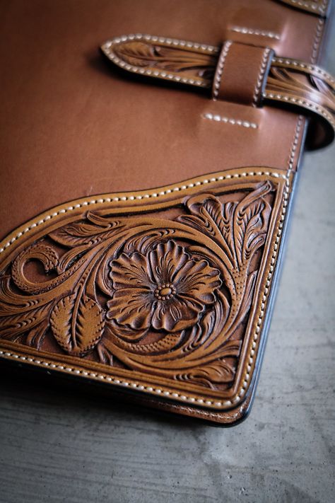 All of our hand tooled portfolios are made one at a time in our shop by Clint Wilkinson. Craftsmanship of this nature takes a tremendous amount of time, so please be patient. Design your own 5x8 Western Notebook Cover with filigreed hand tooled floral corner caps. Comes with 5x8 hard cover notebook. Filigree is the process of removing the background of the western floral design so the base leather will show through. Personalization details will go on the inside bottom left panel. 5.75" x 9" Clos Hand Tooled Leather Portfolio, Western Notebook, Leather Portfolio Case, Handmade Leather Work, Leather Padfolio, Leather Bible Cover, Leather Working Patterns, Leather Patterns, Leather Tooling Patterns