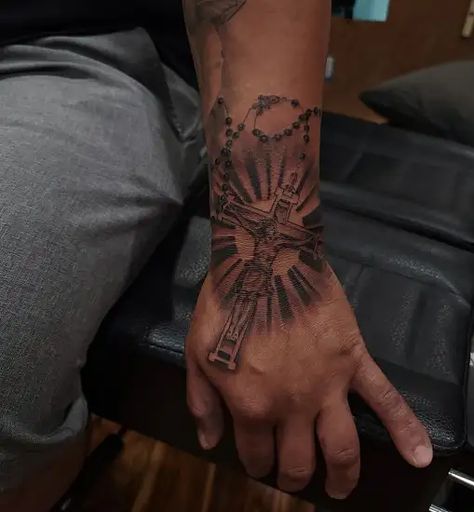 15 Exceptional Jesus Tattoo Designs and Ideas 2023 Angle Arm Tattoo, Rosary Hand Tattoo Men, Christian Hand Tattoos For Men, Jesus Related Tattoos, Cross Hand Tattoo Men, Cross Sleeve Tattoo Men, Jesus Tattoo Design For Men, Forearm Hand Tattoo, Rosary Tattoo For Men