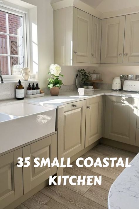 Beige coastal kitchen with window, farmhouse sink, and potted plant on counter. Text: "35 Small Coastal Kitchen". Cottage Coastal Kitchen, Small Beach House Kitchen Coastal, Small Beach House Kitchen, Small Coastal Kitchen Ideas, Small Coastal Kitchen, Coastal Cottage Kitchen, Kitchen Design Tips, Small Farmhouse Kitchen, Coastal Farmhouse Kitchen