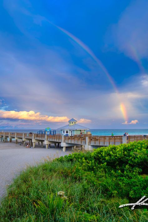 In this captivating image featured on my photo blog, we explore the serene beauty of Juno Beach. The photograph showcases a stunning rainbow gracefully arching over the tranquil waters of the Atlantic Ocean, with the iconic Juno Beach Pier stretching out into the horizon. Juno Beach Florida, Juno Beach, Florida Photography, Beach Pier, Coastal Life, Photo Blog, Sunshine State, Atlantic Ocean