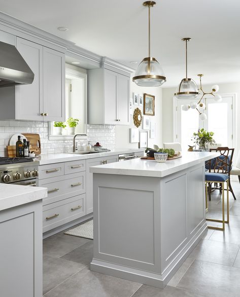 Light grey kitchen with celestial chandelier over kitchen island with white quartz countertops. Kitchen Gray, Model Dapur, Gray Tile, Light Grey Kitchens, Серая Кухня, Grey Kitchen Designs, Desain Pantry, Gray And White Kitchen, White Kitchen Remodeling