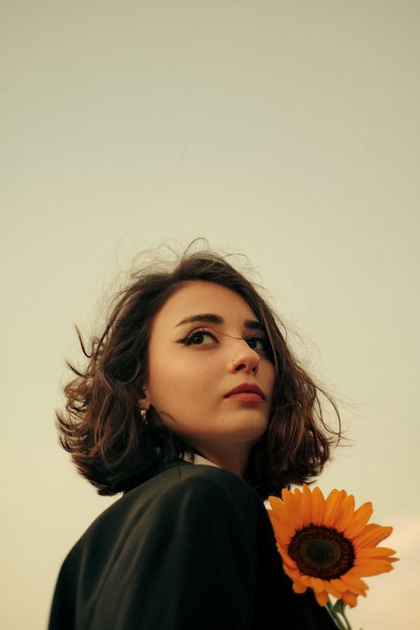 Portrait of a Woman with a Sunflower · Free Stock Photo Sunflower Portrait, Portrait Of A Woman, Clear Sky, Free Photos, Stylish Women, Free Stock Photos, Flower Power, Feathers, Portrait Photography