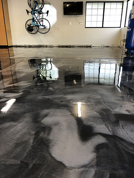 A close up of a two color grey metallic epoxy garage floor. Black And White Epoxy Garage Floor, Black Epoxy Garage Floor, Epoxy Garage Floor Colors, Epoxy Garage Floor Ideas, Storefront Inspiration, Garage Epoxy Floor, Garage Floor Finishes, Flooring Epoxy, Epoxy Garage Floor Coating