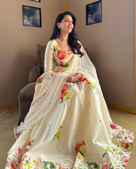 *♥️💐KF KRITVA FASHION PRESENTING #NORA_FATEHI INSPIRED LONG GOWN IN HEAVY MUSLIN COTTON FABRIC WITH BEAUTIFUL FLORAL DIGITAL PRINTING AND EMBROIDERY WORK ON IT💐❤️ # FABRIC DETAILS:- 👉 GOWN :*HEAVY MUSLIN COTTON WITH DIGITAL PRINT & EMBROIDERY WORK* (FULLY STITCH) (*3 MTR FLAIR*) 👉🏻 INNER : MICRO CREPE 👉🏻 DUPATTA: HEAVY GEORGETTE WITH *DIGITAL PRINT LACE & EMBROIDERY WORK* # SIZE DETAILS: 👉 Gown Fullystitched up to 44 Size 👉🏻 Gown Length is 56-57 inch *A-ONE QUALITY* single & bulk order... Floral Anarkali Dresses, Partywear Dresses Indian, Floral Anarkali, White Anarkali, Long Anarkali, Desi Wedding Dresses, Nora Fatehi, Partywear Dresses, Desi Aesthetic