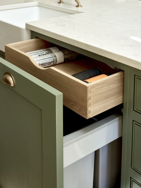 This hidden drawer above an integrated pull-out bin is great for storing bin liners, keeping your kitchen cupboards organised. Shaker cupboards painted in Farrow & Ball Green Smoke (No. 47). Bin Cupboard, Pull Out Bin, Hidden Drawer, Kitchen Sink Storage, London Kitchen, Kitchen Pulls, Shaker Cabinets, Oak Kitchen, Kitchen Bin