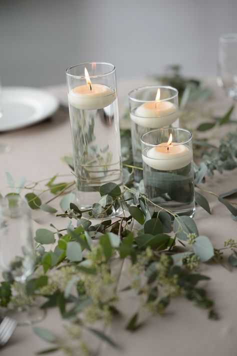 A simple centerpiece using our 3 tiered cylinders and a touch of greenery #love #centerpiece #wedding #candles #decor Lines from- Flexx Productions  Photo By- Sean Lara  Venue- Windsong Estate 3 Tier Candle Centerpiece, Tiered Candle Centerpiece, Cylinder Vase Centerpiece Wedding, Centerpiece Wedding Candles, November Wedding Centerpieces, Wedding Centerpieces Simple, Cylinder Vase Centerpiece, Centerpieces Simple, Simple Centerpiece