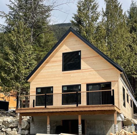 Knotty pine cabin in the woods with pine and black windows. Knotty Pine Cabin Interior, Cheap House To Build, Pre Fab Cabins, Simple Cabin Design, Scandinavian Cabin Design, Cabin Style Home Exterior, Modern Knotty Pine, Chalet Style Homes Floor Plans, A Frame Cabin Interior Ideas