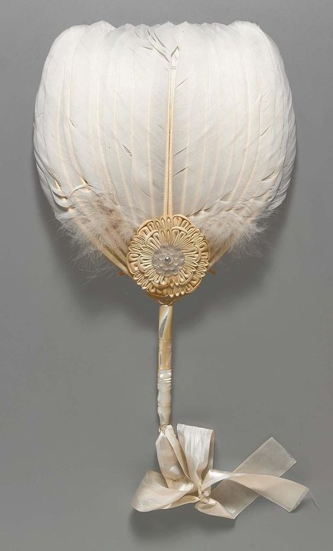 White feather fan with carved mother-of-pearl handle, white cloth rosette at base with shell blossom at center held in place with a metal grommet, white silk satin rib … Antique Fans, Feather Fan, Vintage Fans, Hand Held Fan, Chatelaine, Historical Fashion, Vintage Accessories, Hand Fan, Silk Satin