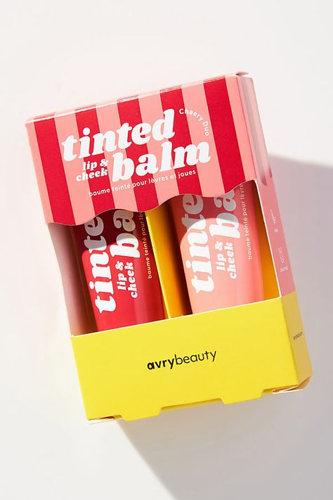 These multi-use balms melt into skin for a wash of blendable, buildable, beautiful color. | Duo Lip & Cheek Tinted Balm Set by AvryBeauty in Red at Anthropologie Colorful Product Packaging, Fancy Makeup Packaging, Unique Makeup Packaging, Lip Balm Packaging Design, Lip Tint Packaging Ideas, Holi Packaging, Lip Balm Packaging Ideas, Lip Balm Design, Fun Packaging Design