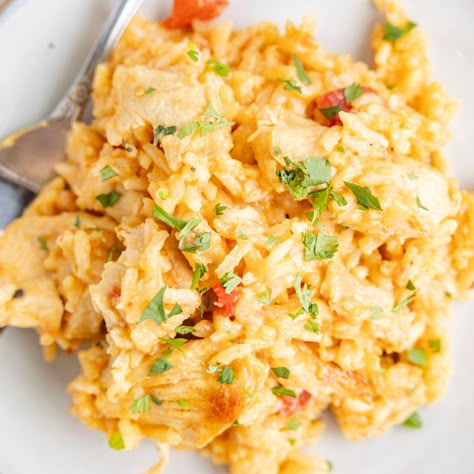 A plate of a serving of this recipe with a fork. Queso Chicken And Rice, White Cheese Sauce, Queso Chicken, White Queso, Chicken Pineapple, Easy Chicken And Rice, Nacho Cheese Sauce, Flavorful Dinner, Fluffy Rice