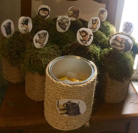 Where The Wild Things Are Centerpieces: I made these with formula cans, twine, foam balls (half circles), a bag of green moss, printed images on paper cut out, toothpicks, and hot glue. I purchased the items at the dollar store and Michael’s 🙂 Where The Wild Things Are Table Centerpiece, Where The Wild Things Are Centerpieces 1st Birthdays, Where The Wild Things Are Centerpieces, Wild Things Party, Adventure Birthday Party, Wild Rumpus, Wild Birthday Party, Wild Party, Wild One Birthday Party