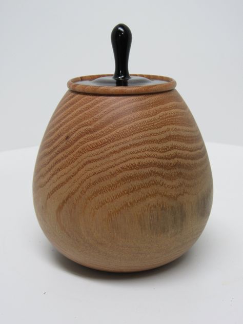 This a neat little lidded box made of an unknown wood, that would make a great trinket box or small pet urn, or just a shelf decoration. The lid of this piece is extremely tight fitting so it wouldn't make for a good in and out of box. The dimensions are 3.75" tall without lid and 5.25" with lid. Slightly less than 4" in diameter at the widest point with an opening of 1.75" and a depth of 3". Artist name and year are laser engraved on the bottom.   Thanks for looking! Wooden Pot, Shelf Decoration, Pet Urn, Pet Urns, Small Pet, A Shelf, Shelf Decor, Trinket Boxes, Laser Engraved