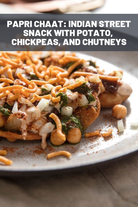 Papri Chaat (Indian Street Snack With Potato, Chickpeas, and Chutneys) Recipe | Much like nachos, the papris are topped with assorted accoutrements of complementing and contrasting textures and flavors, and always dusted generously with chaat masala, a fragrant and flavorful spice mixture.  #newyearseve #appetizers #partyfood #cocktailparty #seriouseats #recipe Chat Papri Recipe, Chaat Papri Recipe, Chutneys Recipe, Papri Chat, Papri Chaat Recipe, Chaat Indian, Papri Chaat, Chats Recipe, Contrasting Textures