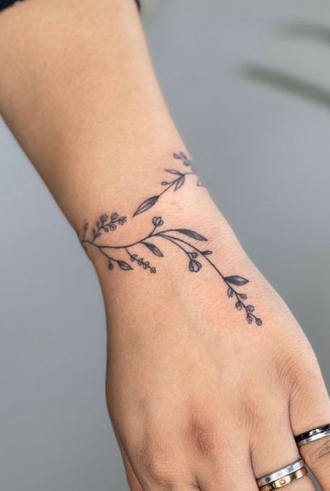 #InkedArt #TattooInspiration #BodyArt #TattooDesigns #TattooIdeas #InkAddict #TattooCommunity #TattooLovers #TattooCulture #TattooedLife Heart Bracelet Tattoo, Feminine Hand Tattoos, Arm Cuff Tattoo, Wrap Around Wrist Tattoos, Botanical Tattoos, Cuff Tattoo, Magic Runes, Wrap Tattoo, Finger Tattoo For Women