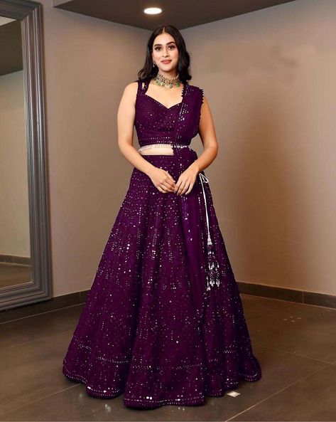 Steal the hearts away with this exotic navy blue color lehenga in georgette material embellished with all-over sequins and embroidery work comes with an attached can-can inside. Paired with similar choli material and net dupatta with similar sequins work. Party to attend? This navy blue lehenga is all you need to make a stunning party look. Sequins work on the lehenga giving that party vibes by its glittery effect. Any woman can wear this lehenga at a party, wedding, Garba, or any family functio Wine Colour Designer Saree, Purple Reception Lehenga, Grape Wine Color Lehenga, Sequence Lehenga Designs, Designer Choli For Wedding, Banarsi Lehenga Blouse Designs, Wine Colour Lehenga Color Combos, Heavy Lehenga Designs, Lehenga Designs For Reception