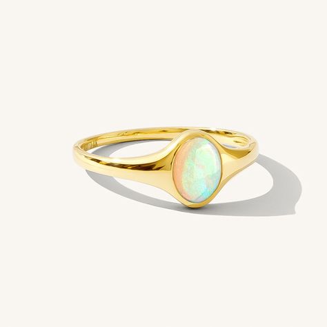 Meet your new favorite statement ring - the Opal Signet Ring. With just the right amount of sparkle and flash, this Australian opal ring makes a gorgeous statement by itself - or paired with your favorite stacked rings. It's made of 14k solid gold, so it'll last many lifetimes. After you're done with it, you can pass it on as an heirloom! DETAILS 14k solid gold ring 5mm x 7mm Australian opal Available in sizes 5-8 Weight: 1.5g Safe for sensitive skin & shower safe Matching jewelry: Oval Opal Nec Modern Opal Ring, White Gold Opal Ring, Oval Opal Ring, Fire Opal Engagement Ring, Opal Wedding Ring, Stacked Rings, Australian Opal Ring, Silver Opal Ring, Nature Inspired Rings